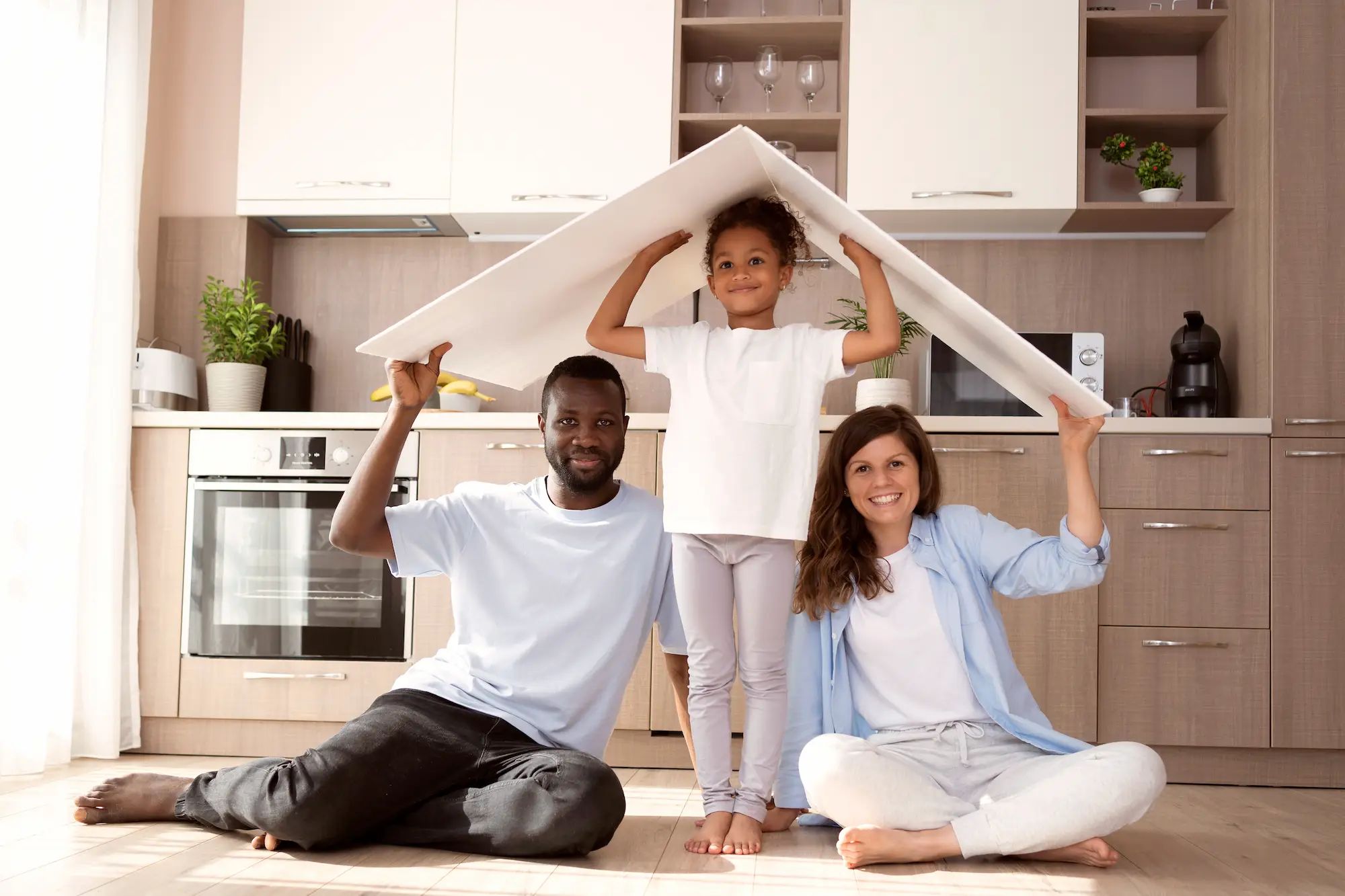 Young family holding roof-shaped plastic sheets over their heads.